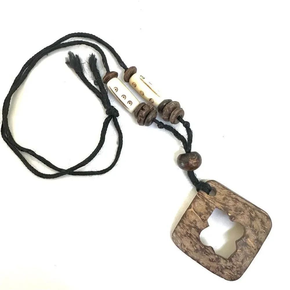 Coconut shell pendant necklace on cord
